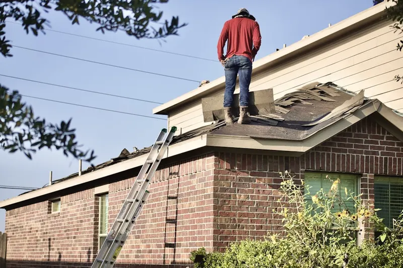 Professional roofer working on a residential roof in Hazen